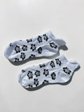 Black hibiscus ankle socks on white background with tropical floral print, 100% cotton made in USA
