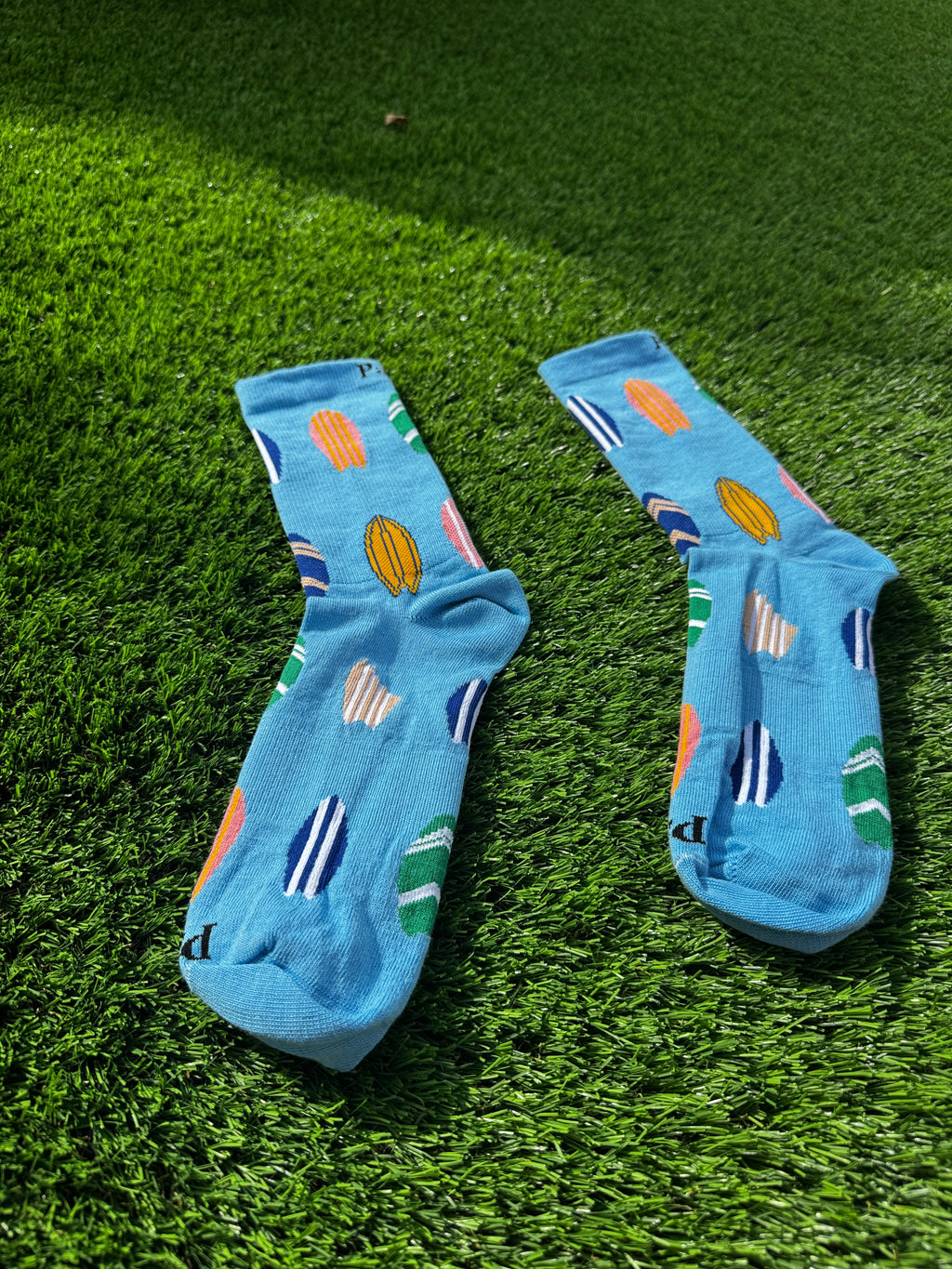 Surfboard crew socks side view showing colorful surfboard design detail