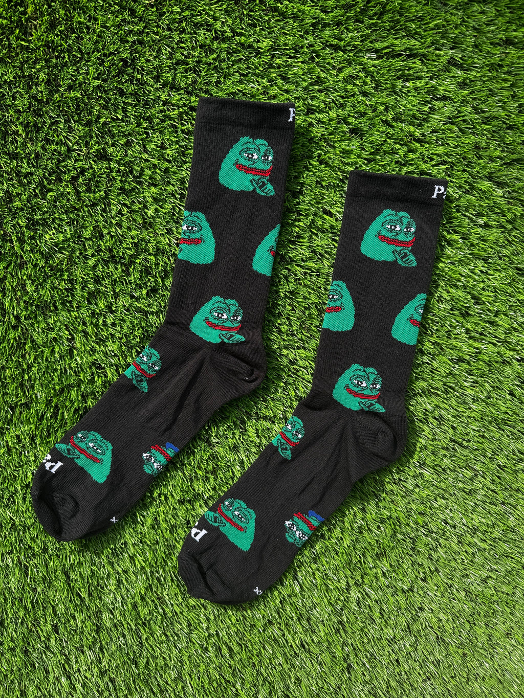 Smug Pepe crew socks with iconic meme character on black background, 100% cotton made in USA