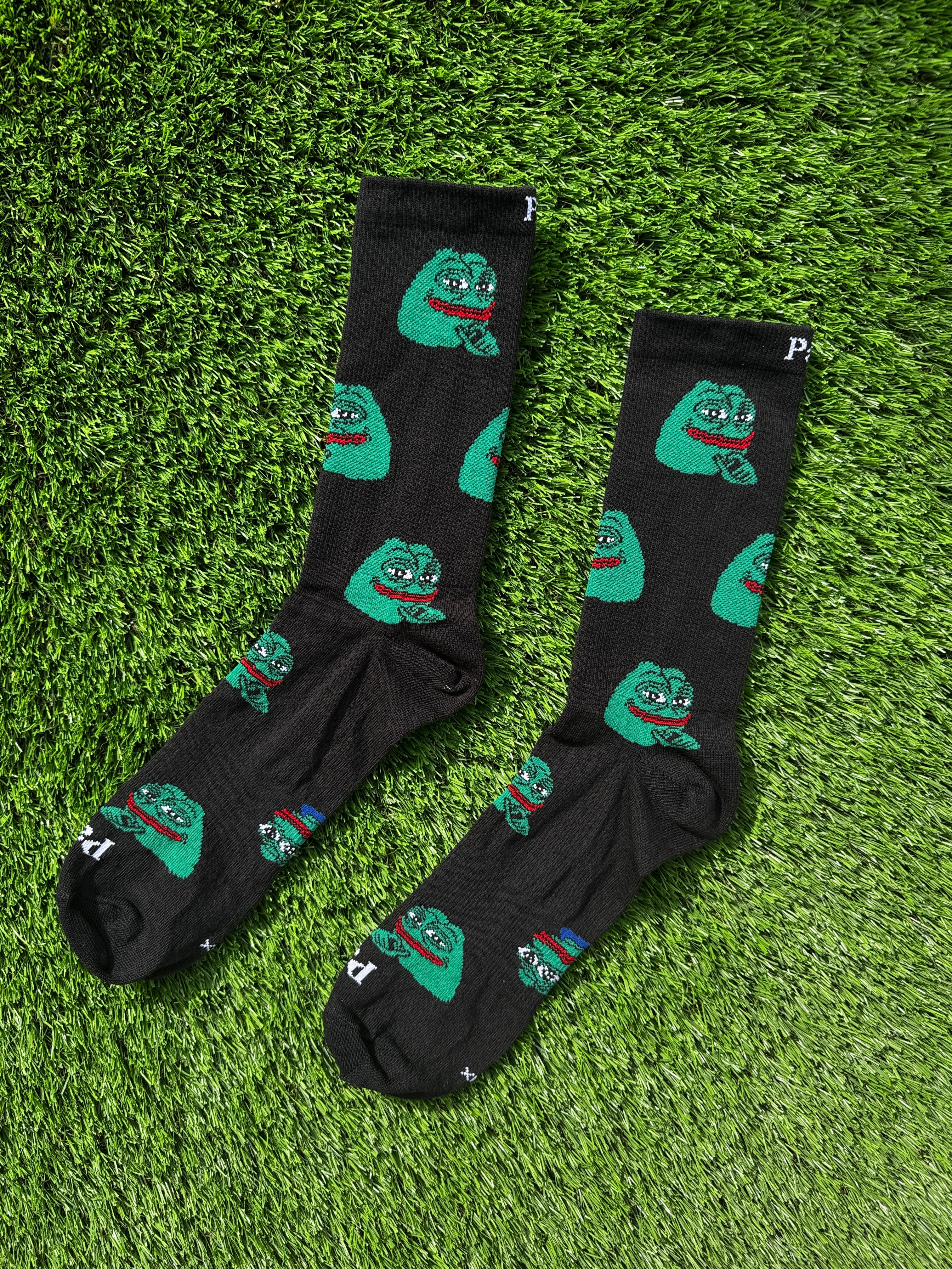 Smug Pepe crew socks with iconic meme character on black background, 100% cotton made in USA