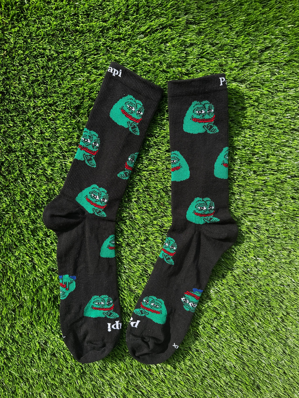 Smug Pepe crew socks flat lay showing full meme design detail, premium cotton
