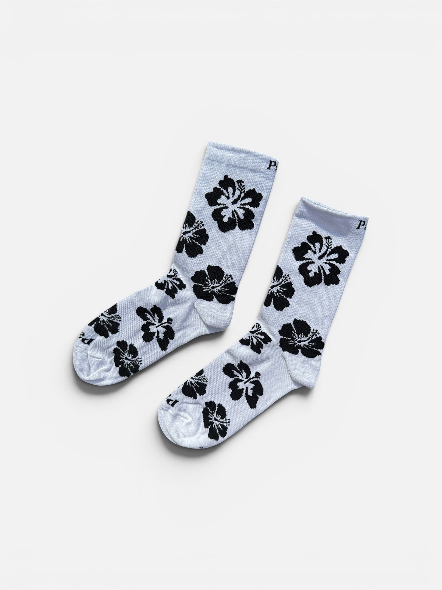 Black hibiscus crew socks featuring bold floral print on dark background, 100% cotton made in USA