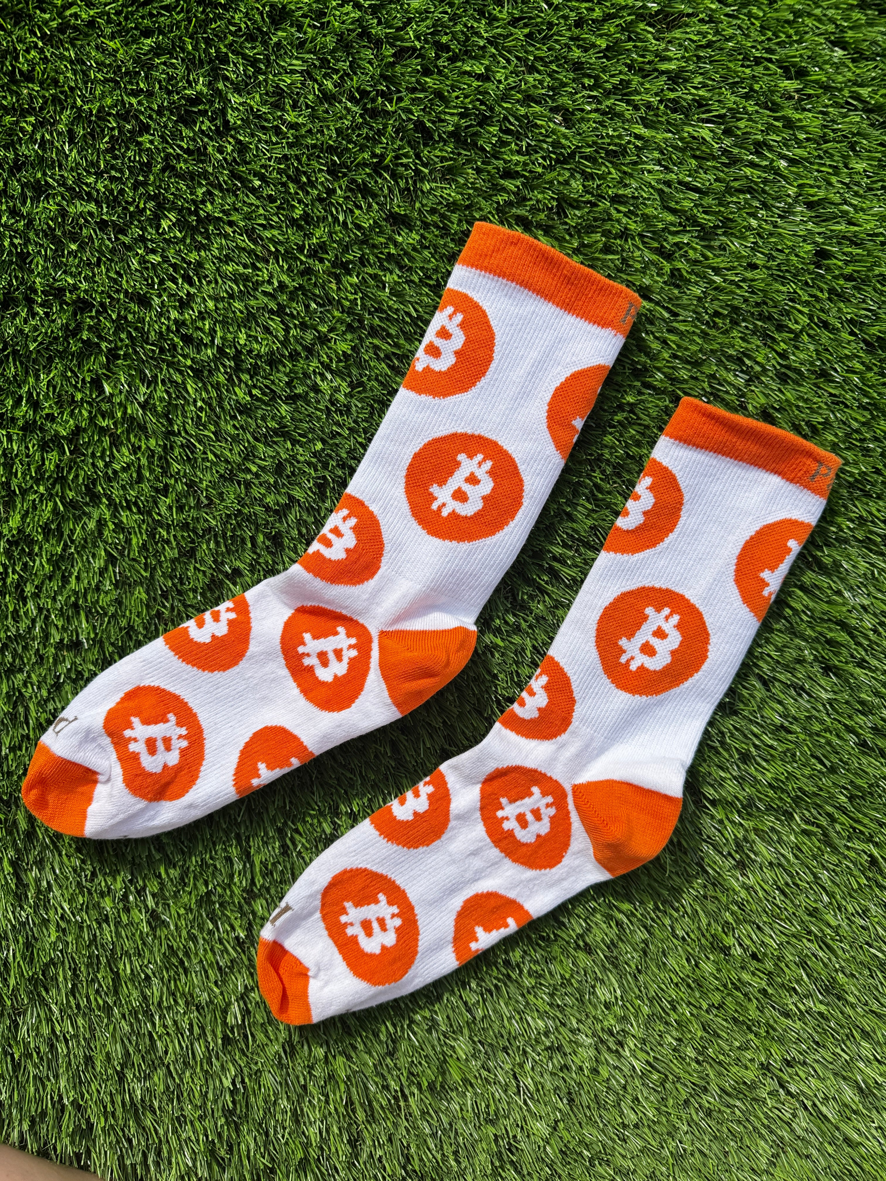 Bitcoin crew socks laid flat on white background, 100% combed cotton made in USA
